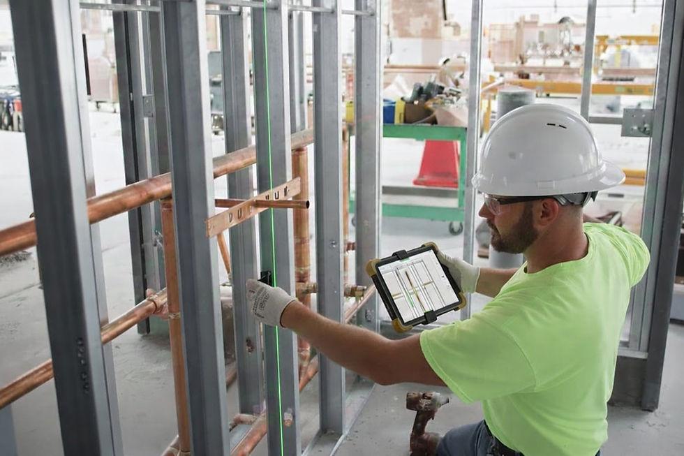 Construction professional using a tablet during field documentation